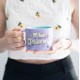 Taza morada BT21 The Journey con personajes animados.