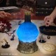 Lámpara azul con forma de poción en base medieval