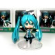 Figurines and Hatsune Miku on stage